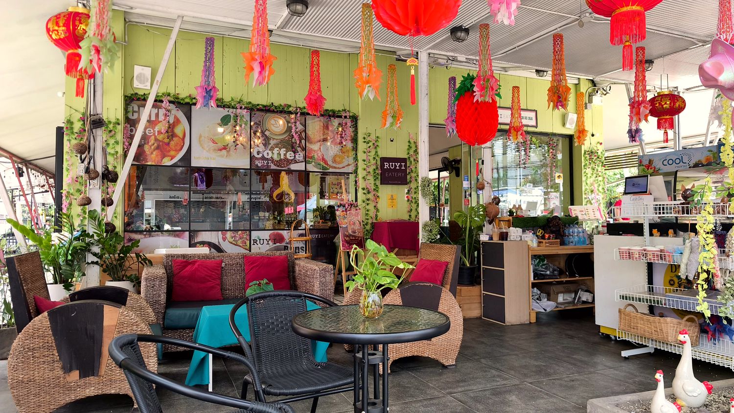 Interior with red lanterns, plants and sofas