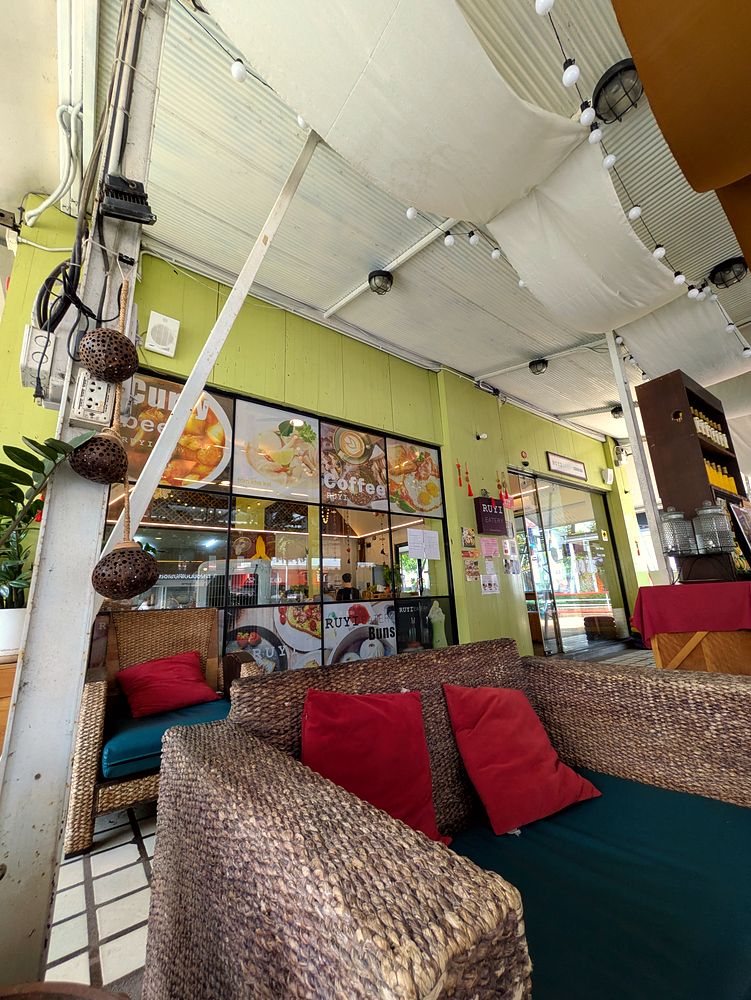 Woven sofas with red cushions