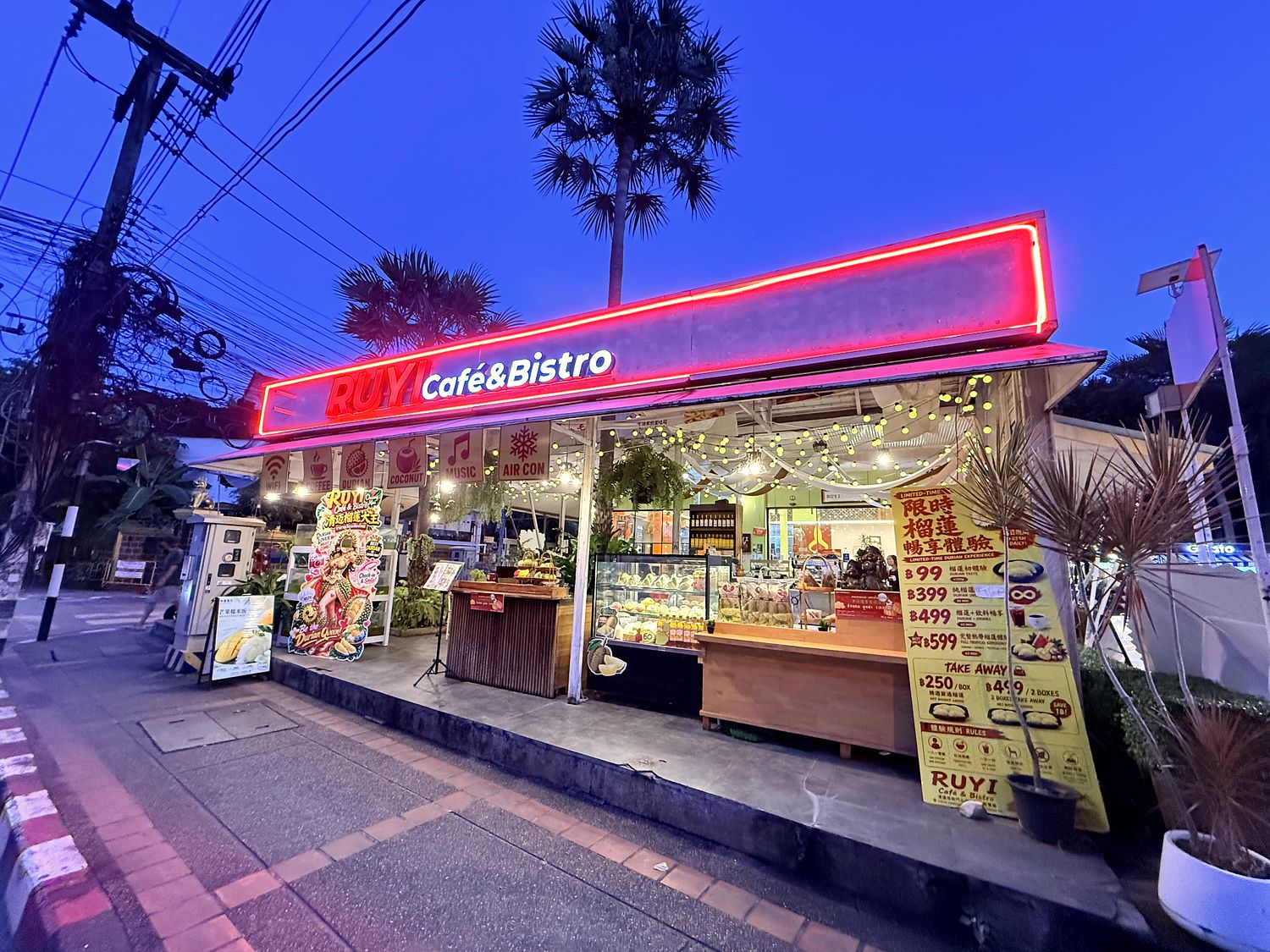 Ruyi Café & Bistro shopfront at dusk with the red neon sign