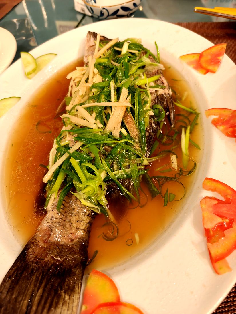 Whole fish in broth with herbs